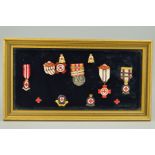 A GLAZED FRAME CONTAINING A COLLECTION OF BRITISH RED CROSS MEDALS, lapel badges and achievement