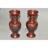 A PAIR OF ORIENTAL BRONZE VASES, with patinated finish, twin handles, cast foliage decoration,