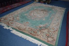 A WOOLLEN CHINESE GREEN GROUND CARPET SQUARE, with foliate detail, approximate size 370cm x 279cm