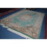 A WOOLLEN CHINESE GREEN GROUND CARPET SQUARE, with foliate detail, approximate size 370cm x 279cm