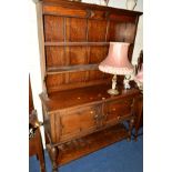 AN EARLY 20TH CENTURY OAK DRESSER, the upper section with two shelves above double cupboard doors