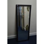 AN EARLY 20TH CENTURY RECTANGULAR OAK BEVELLED EDGE WALL MIRROR with geometric detail, 138cm x 50cm