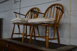 A PAIR OF BLONDE ERCOL BEECH STICK BACK ARMCHAIRS (sd) together with a teak tile topped nest of