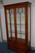 A BEVAN FUNNELL BURR WALNUT ASTRAGAL GLAZED TWO DOOR DISPLAY CABINET with three adjustable glass