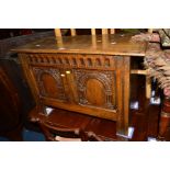 A REPRODUCTION CARVED OAK COFFER, width 85cm x depth 40cm x height 56cm (sd)