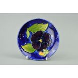 A MOORCROFT POTTERY PIN DISH, 'Pansy' pattern on blue ground, diameter 11.5cm