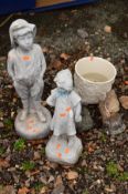 A COMPOSITE GARDEN FIGURE OF A BOY and another of a girl, together with two small squirrel ornaments