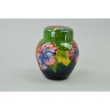 A SMALL MOORCROFT POTTERY GINGER JAR, 'Hibiscus' pattern on green ground, impressed marks to base,