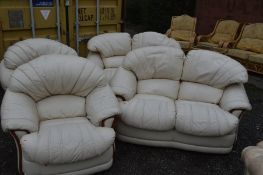 A FOUR PIECE CREAM LEATHER LOUNGE SUITE comprising of a pair of two seater settee and two chairs (