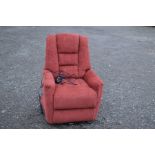 A RED UPHOLSTERED RECLINING CHAIR
