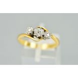 A THREE STONE DIAMOND RING, the central brilliant cut diamonds flanked by single cut diamonds, all