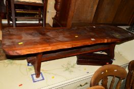 A NATURALISTIC YEW WOOD COFFEE TABLE on a stretchered base