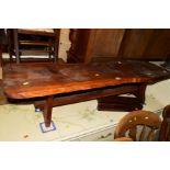 A NATURALISTIC YEW WOOD COFFEE TABLE on a stretchered base