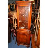 A MODERN REPRODUX STYLE MAHOGANY GLAZED CORNER CUPBOARD