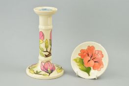 TWO PIECES OF MOORCROFT POTTERY, to include candlestick, 'Magnolia' pattern on cream ground,