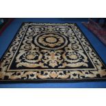 A WOOLLEN BLACK GROUND CARPET SQUARE with gold foliate detail, label to underside reading G H