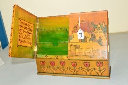 AN ARTS AND CRAFTS POKER WORK STATIONARY BOX, the twin doors decorated with a Peacock and town scene