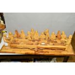 A CARVED WOODEN MODEL OF THE LAST SUPPER, Jesus and the Disciples sat around a long wooden table,