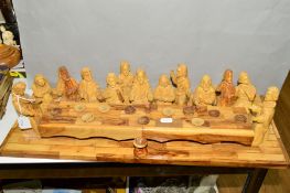 A CARVED WOODEN MODEL OF THE LAST SUPPER, Jesus and the Disciples sat around a long wooden table,