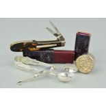 FOUR ACCESSORIES to include a pair of silver sugar tongs, a silver circular pill box with embossed