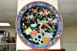 A JAPANESE CERAMIC CHARGER, the central panel decorated with a pair of exotic birds perched in a