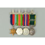 A SWING MOUNTED WWII GROUP OF FOUR MEDALS, as follows, 1939-45 Star, Defence and War medal, together