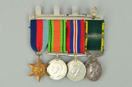 A SWING MOUNTED WWII GROUP OF FOUR MEDALS, as follows, 1939-45 Star, Defence and War medal, together