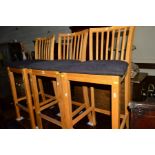 A SET OF THREE LIGHT OAK BAR STOOLS