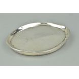 A GEORGE III OVAL SILVER TEA POT STAND, worn bright cut decoration, mounted wooden base, London