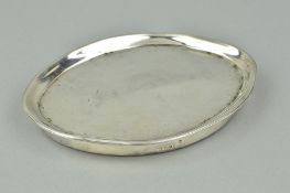 A GEORGE III OVAL SILVER TEA POT STAND, worn bright cut decoration, mounted wooden base, London