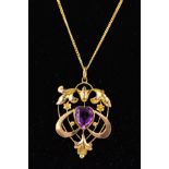 AN EARLY 20TH CENTURY GOLD PASTE PENDANT, the central heart shaped purple paste within an openwork