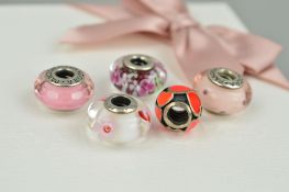 FIVE PANDORA CHARMS AND A MAKERS BOX to include two glass charms with floral detail, one glass charm