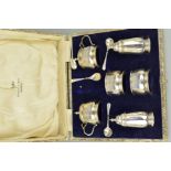 A CASED GEORGE V SIX PIECE SILVER CRUET SET, of panelled form, comprising pair of pepperettes,