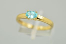 A 9CT GOLD GEM RING, the oval shape gem assessed as apatite within a four claw setting to a plain