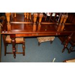 A REPRODUCTION MAHOGANY RECTANGULAR SIDE TABLE with fold over top on turned legs, approximate