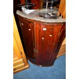 A GEORGIAN MAHOGANY AND INLAID BOWFRONT TWO DOOR HANGING CORNER CUPBOARD