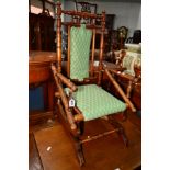 AN EDWARDIAN OAK AND MAHOGANY AMERICAN CHILDS ROCKING CHAIR