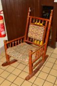 AN EARLY 20TH CENTURY DECORATIVELY PAINTED ROCKING CHAIR (sd)