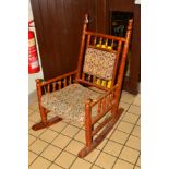 AN EARLY 20TH CENTURY DECORATIVELY PAINTED ROCKING CHAIR (sd)