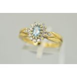 A 9CT GOLD GEM CLUSTER RING, designed with a central oval blue gem assessed as aquamarine, within