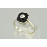 AN ONYX AND DIAMOND RING designed as a central old cut diamond within a collet setting atop an
