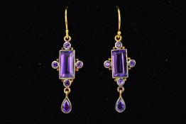 A PAIR OF AMETHYST DROP EARRINGS, the central rectangular amethyst within a four circular amethyst