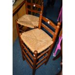 A PAIR OF STAINED RUSH SEATED BAR STOOLS and a painted towel rail (3)