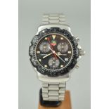 A TAG HEUER FORMULA ONE CHRONOGRAPH WATCH, the black face with three subsidiary dials and date dial,