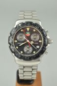 A TAG HEUER FORMULA ONE CHRONOGRAPH WATCH, the black face with three subsidiary dials and date dial,