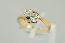 A TWO STONE CROSSOVER DIAMOND RING, the two single cut diamonds within illusion settings to the