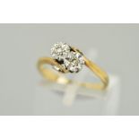 A TWO STONE CROSSOVER DIAMOND RING, the two single cut diamonds within illusion settings to the