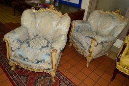 A PAIR OF EARLY 19TH CENTURY GILTWOOD AND PAINTED ROCOCO ARMCHAIRS with pale blue floral upholstery