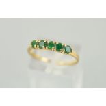 A 9CT GOLD FIVE STONE EMERALD RING, the five circular emeralds within claw settings to the plain