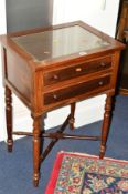 AN EDWARDIAN MAHOGANY SIDE TABLE with two drawers on turned legs united by a cross stretcher,